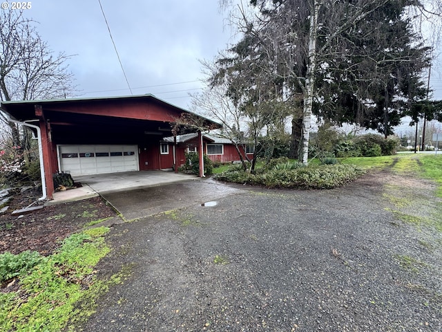 view of home's exterior with a garage and driveway