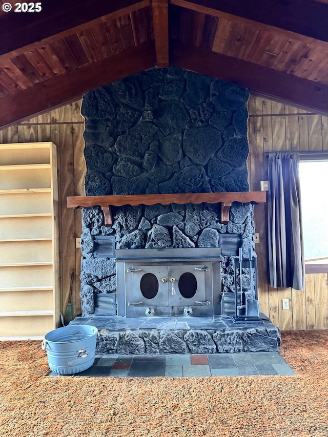 details featuring beamed ceiling, a stone fireplace, wood walls, and wooden ceiling