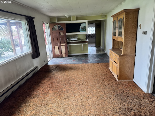 kitchen featuring baseboard heating, stone finish floor, carpet flooring, and baseboards