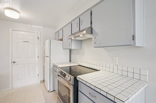 6250 SW 152nd Ave, Beaverton, OR 97007 - kitchen with stainless steel range with electric cooktop, exhaust hood, tile countertops, and gray cabinets