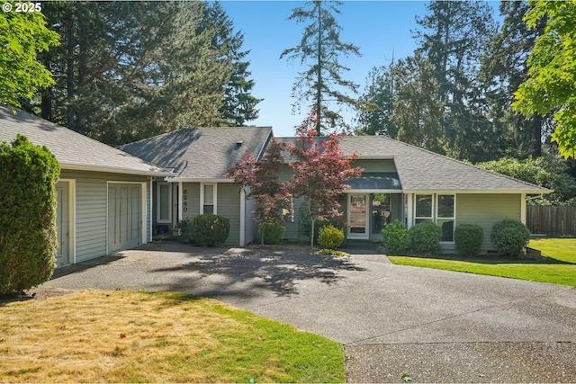 6250 SW 152nd Ave, Beaverton, OR 97007 - view of front facade with asphalt driveway, a garage, a front lawn, and a shingled roof