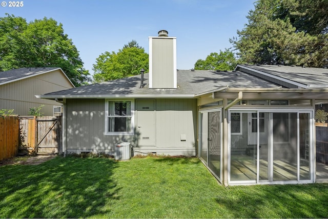 6250 SW 152nd Ave, Beaverton, OR 97007 - rear view of house featuring a sunroom, a chimney, a gate, and roof with shingles