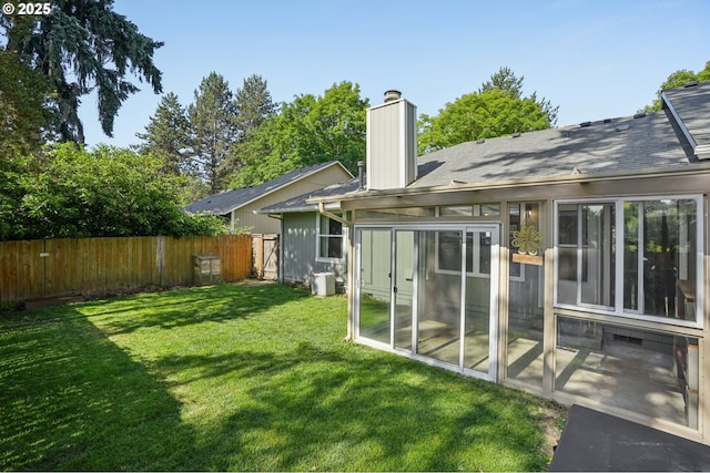 6250 SW 152nd Ave, Beaverton, OR 97007 - rear view of property with a chimney, a patio, a sunroom, and a shingled roof