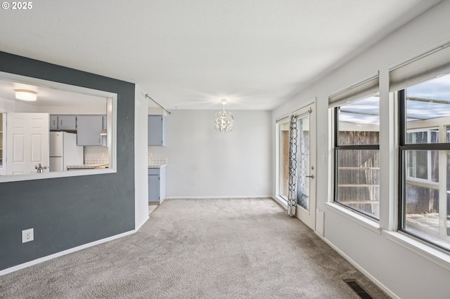 6250 SW 152nd Ave, Beaverton, OR 97007 - carpeted empty room with a chandelier and healthy amount of natural light