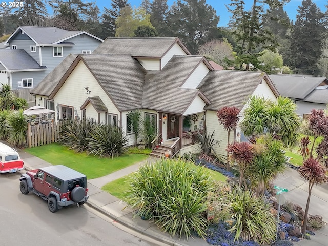 6931 Oakwood Ct, Brookings, OR 97415 - view of front facade with fence and a shingled roof