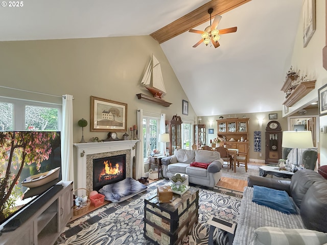6931 Oakwood Ct, Brookings, OR 97415 - living room featuring high vaulted ceiling, a healthy amount of sunlight, a ceiling fan, and a warm lit fireplace