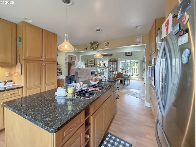 6931 Oakwood Ct, Brookings, OR 97415 - kitchen featuring pendant lighting, freestanding refrigerator, light wood-type flooring, gas cooktop, and a kitchen island