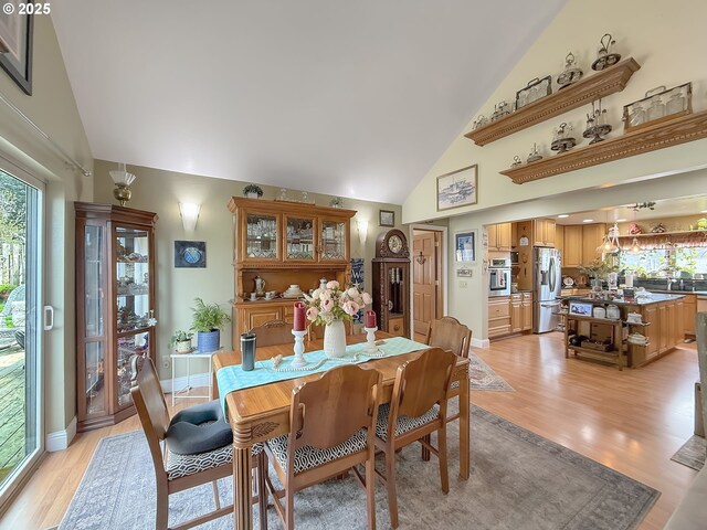 6931 Oakwood Ct, Brookings, OR 97415 - dining area featuring high vaulted ceiling and light wood finished floors