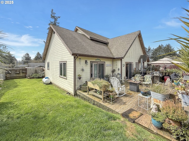 6931 Oakwood Ct, Brookings, OR 97415 - rear view of house with roof with shingles, a wooden deck, fence, and a lawn