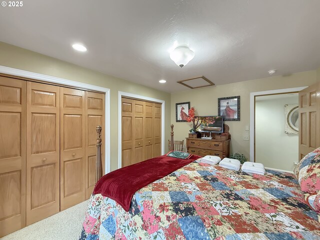 6931 Oakwood Ct, Brookings, OR 97415 - carpeted bedroom featuring two closets, recessed lighting, and attic access