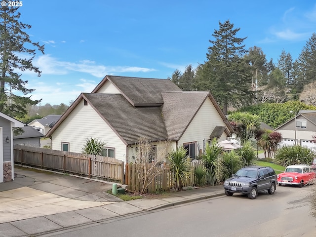 6931 Oakwood Ct, Brookings, OR 97415 - view of property exterior featuring roof with shingles and fence