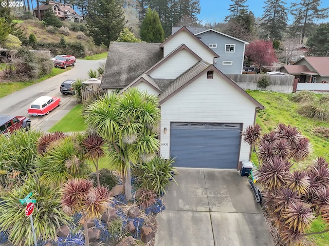 6931 Oakwood Ct, Brookings, OR 97415 - traditional home featuring fence, a garage, driveway, and roof with shingles