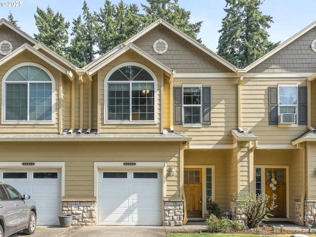 15235 SW Jasper Ln, Beaverton, OR 97007 - multi unit property featuring a garage, driveway, stone siding, and cooling unit