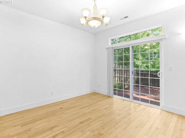 15235 SW Jasper Ln, Beaverton, OR 97007 - spare room featuring a chandelier and light wood-style flooring