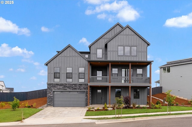 382 W Fir Loop, Washougal, WA 98671 - view of front of house with board and batten siding, concrete driveway, a balcony, a garage, and stone siding