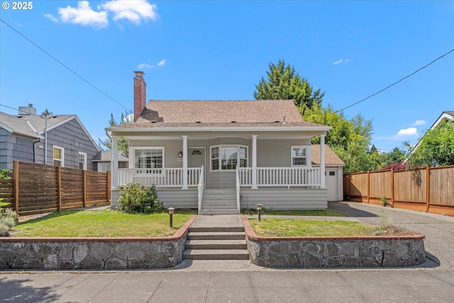 4912 N Yale St, Portland, OR 97203 - bungalow-style home featuring covered porch, a chimney, and a shingled roof