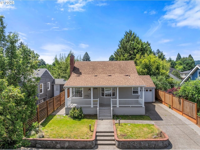4912 N Yale St, Portland, OR 97203 - view of front of home with covered porch, asphalt driveway, a garage, a chimney, and roof with shingles