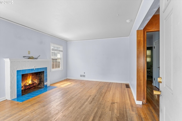 4912 N Yale St, Portland, OR 97203 - unfurnished living room with wood finished floors, baseboards, and a fireplace
