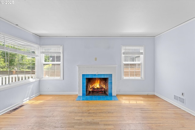 4912 N Yale St, Portland, OR 97203 - unfurnished living room with wood finished floors, plenty of natural light, and a fireplace with flush hearth