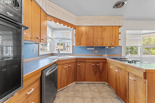4912 N Yale St, Portland, OR 97203 - kitchen featuring stainless steel dishwasher, a sink, black oven, open shelves, and light countertops