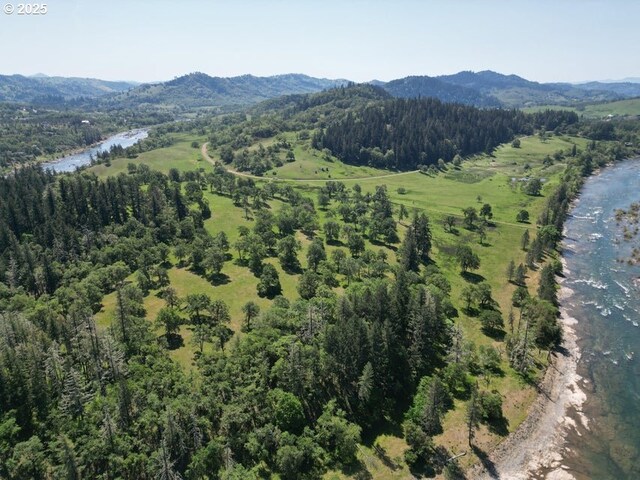 1104 Rio Nes Ln, Roseburg, OR 97470 - aerial overview of property's location with a mountain backdrop and a heavily wooded area