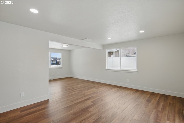 unfurnished room featuring a textured ceiling and wood-type flooring