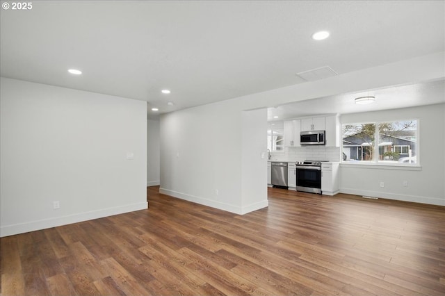 unfurnished living room featuring hardwood / wood-style flooring