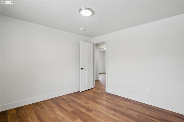 spare room featuring wood-type flooring