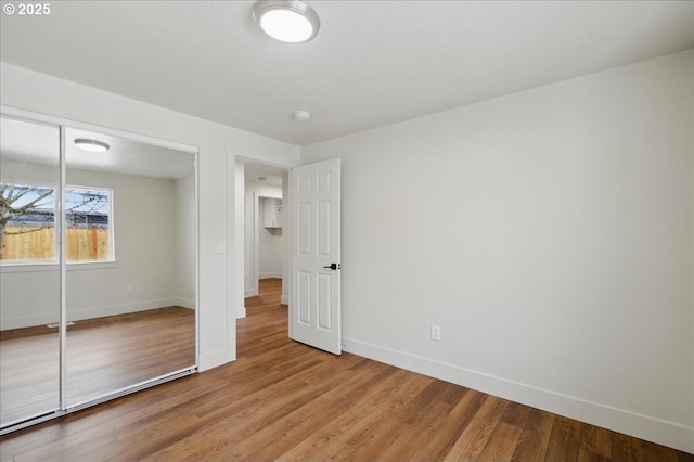 unfurnished bedroom with hardwood / wood-style floors