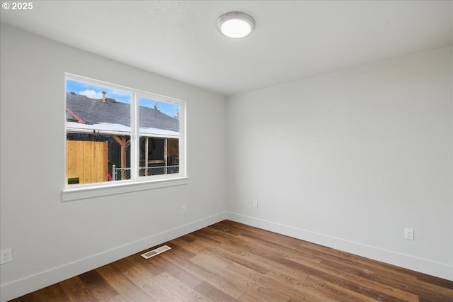 spare room with hardwood / wood-style floors