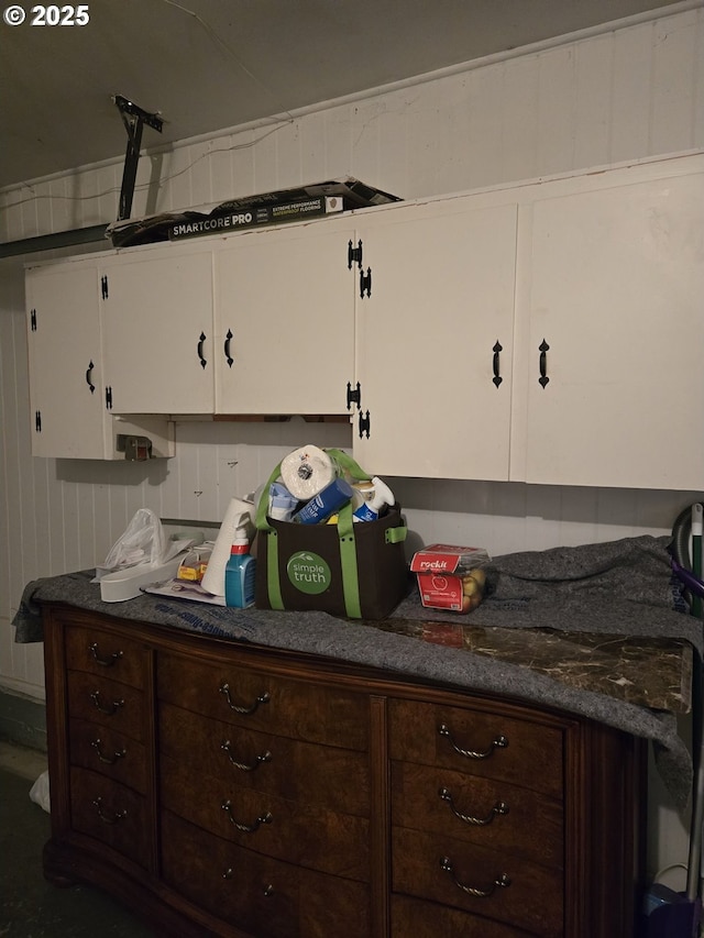 kitchen featuring dark countertops, white cabinetry, and dark brown cabinets