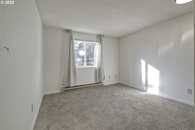 carpeted empty room with a baseboard radiator and a textured ceiling