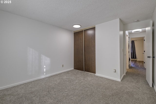 unfurnished bedroom with a textured ceiling, a closet, and carpet flooring