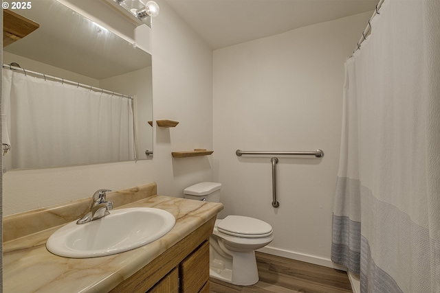 bathroom with wood-type flooring, toilet, and vanity