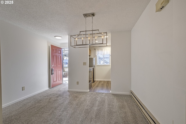 unfurnished dining area featuring a textured ceiling, a baseboard radiator, and carpet flooring