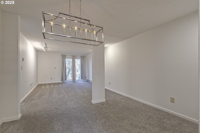 carpeted empty room featuring a textured ceiling