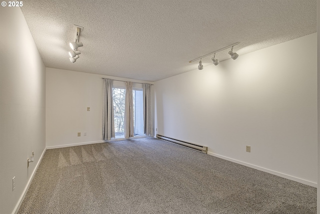 spare room with track lighting, carpet flooring, a baseboard heating unit, and a textured ceiling