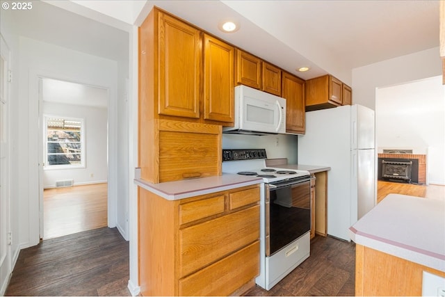 3315 SE 15th Ave, Portland, OR 97202 - kitchen featuring white appliances, dark wood-style floors, light countertops, recessed lighting, and brown cabinets