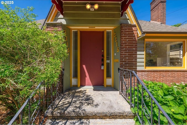 3315 SE 15th Ave, Portland, OR 97202 - view of exterior entry with a chimney, a shingled roof, and brick siding
