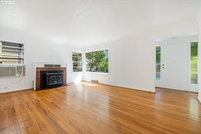 3315 SE 15th Ave, Portland, OR 97202 - unfurnished living room featuring wood finished floors, baseboards, and cooling unit