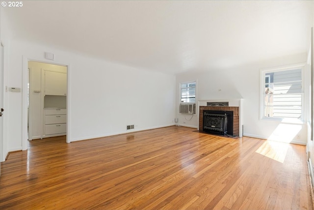 3315 SE 15th Ave, Portland, OR 97202 - unfurnished living room featuring light wood-style flooring, a brick fireplace, and cooling unit