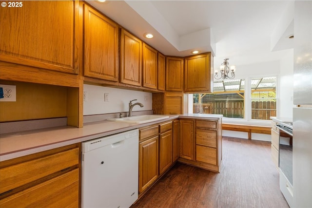 3315 SE 15th Ave, Portland, OR 97202 - kitchen featuring white appliances, a sink, brown cabinets, a chandelier, and recessed lighting