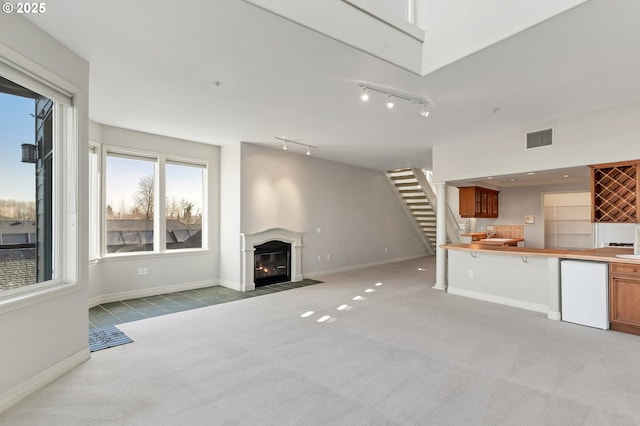 unfurnished living room with light carpet