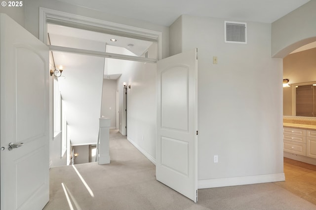 hallway with light colored carpet