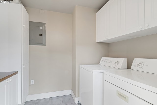 washroom with cabinets, electric panel, washer and dryer, and light tile patterned floors