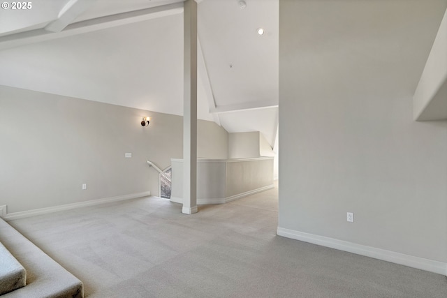 unfurnished living room featuring light colored carpet and lofted ceiling