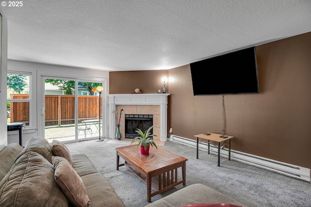 8458 SW Mohawk St, Tualatin, OR 97062 - carpeted living room with a baseboard heating unit, a textured ceiling, a tile fireplace, and baseboards