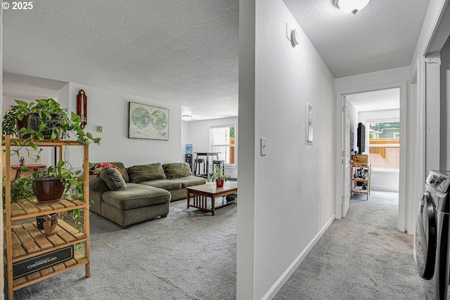 8458 SW Mohawk St, Tualatin, OR 97062 - corridor featuring carpet floors, separate washer and dryer, a textured ceiling, baseboards, and a textured wall
