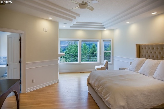 1500 SW Miller Ct, Gresham, OR 97080 - bedroom with light wood finished floors, a tray ceiling, recessed lighting, and baseboards