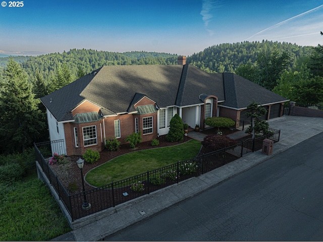1500 SW Miller Ct, Gresham, OR 97080 - view of front of house featuring a view of trees, brick siding, a garage, driveway, and a chimney